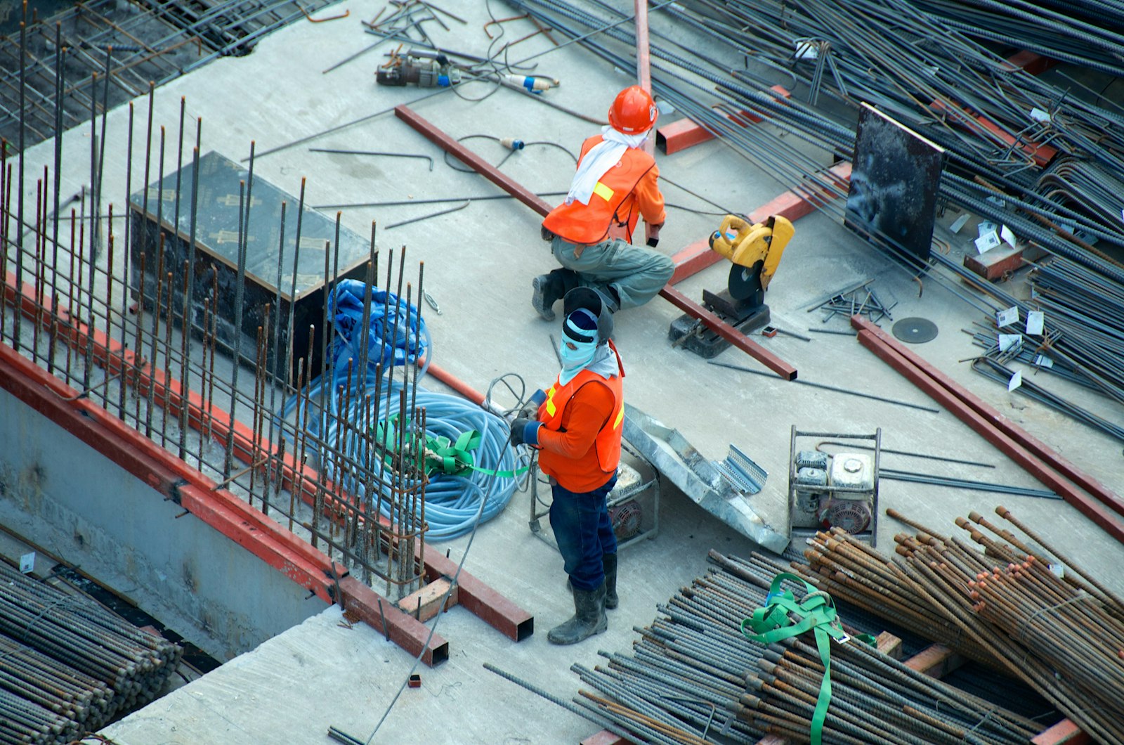 Contractors in safety vests working with steel on a jobsite