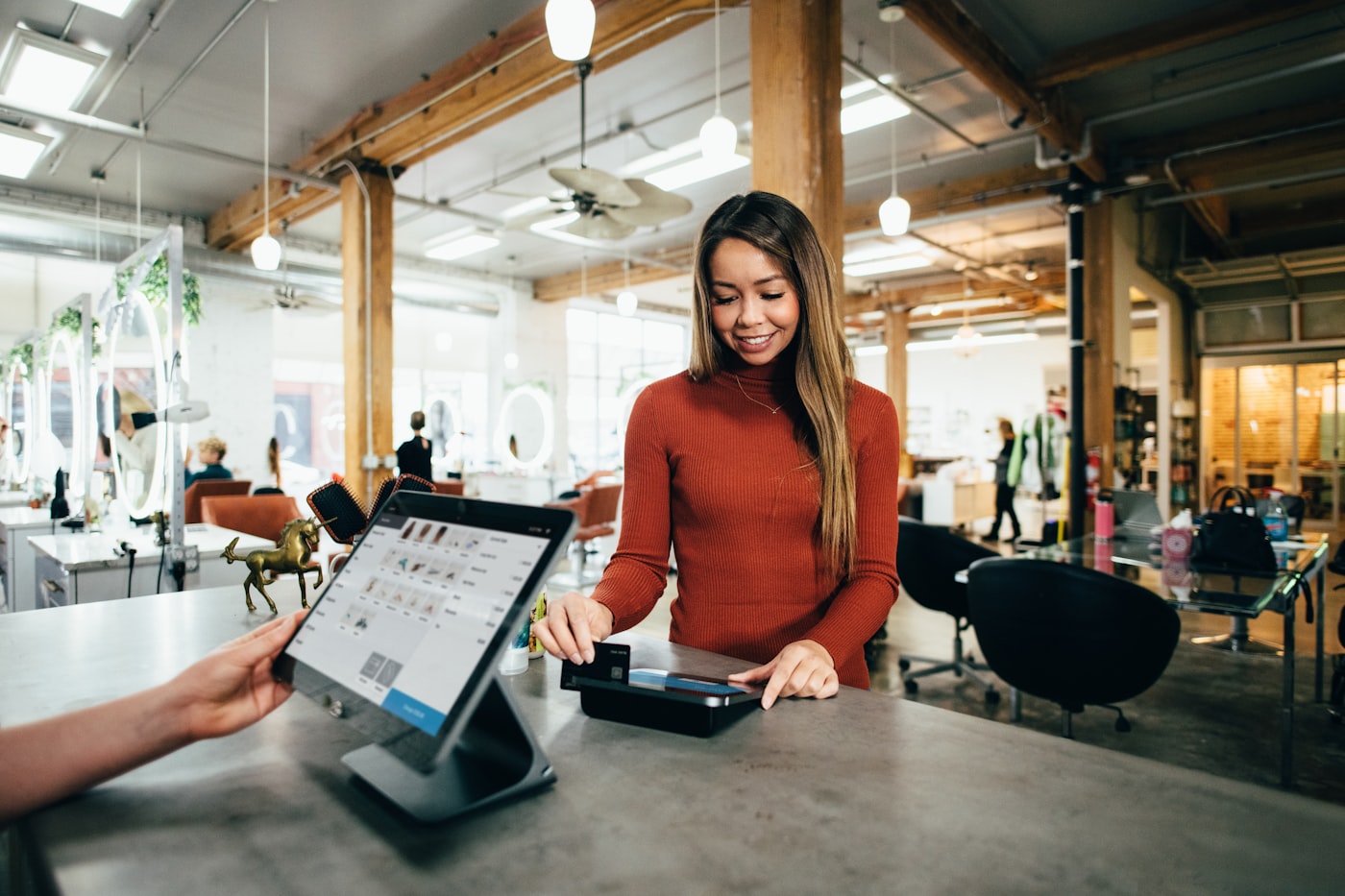 Local business owner helping a customer at the counter